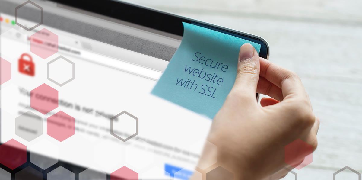 Hand putting sticky note on computer that says "Secure website with SSL"